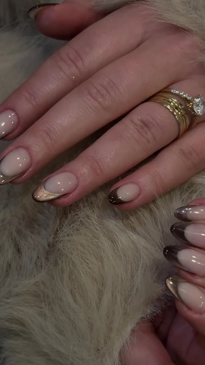 Chrome French almond nails resting on fur