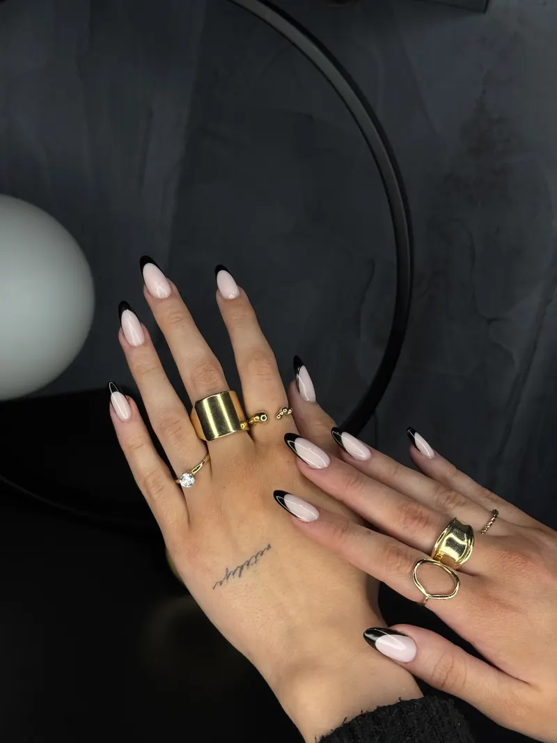Black French almond nails with gold rings